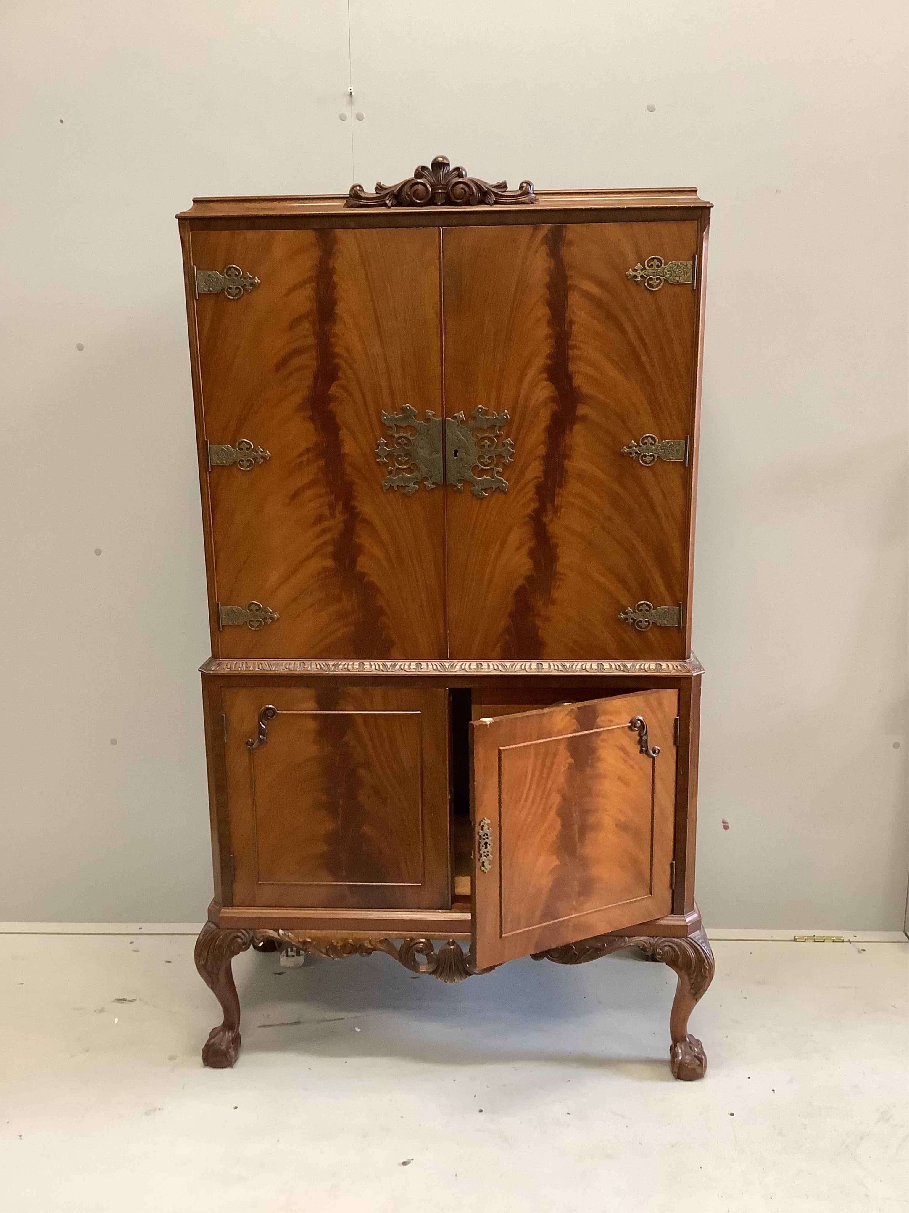 A Queen Anne Revival walnut cocktail cabinet, width 94cm, depth 48cm, height 160cm. Condition - good
